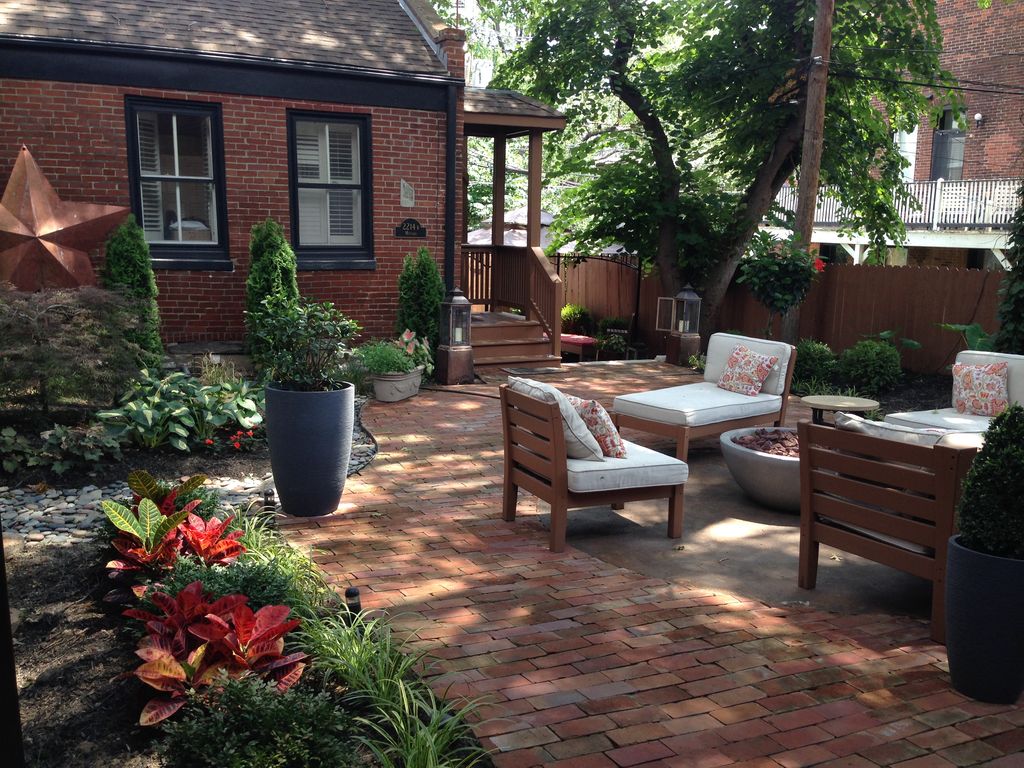 The Grounds courtyard showing outdoor seating, fireplace, and large garden.